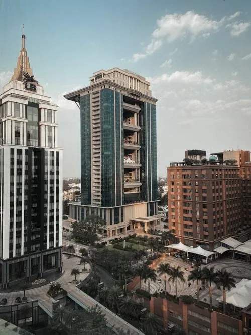 High-rise residential and office towers beside a landscaped plaza